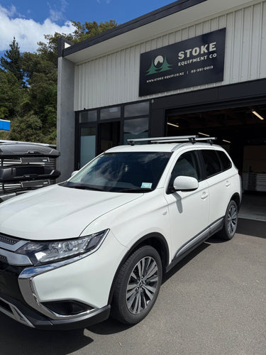 white mitsubishi outlander fitted with a thule wingbar evo roof rack system by stoke equipment co