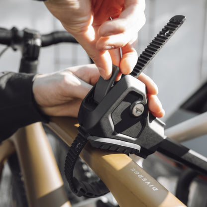 Person adjusting a strap to their bike on a bicycle carrier