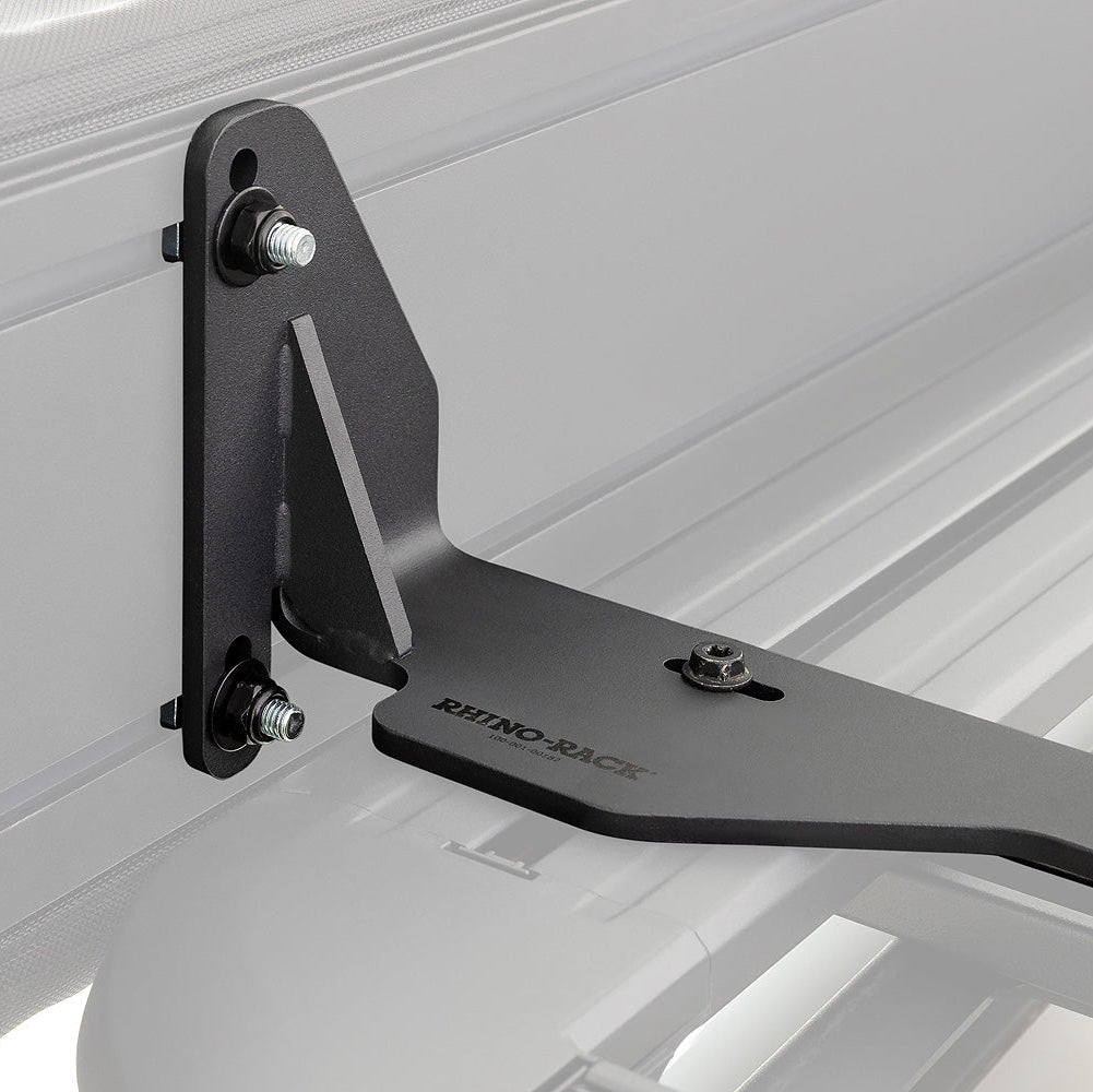 Black metal bracket attached to a white vehicle bed