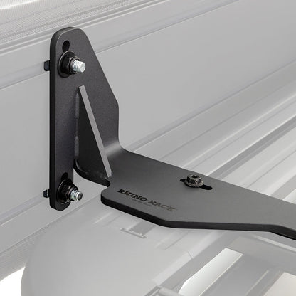 Black metal bracket attached to a white vehicle bed