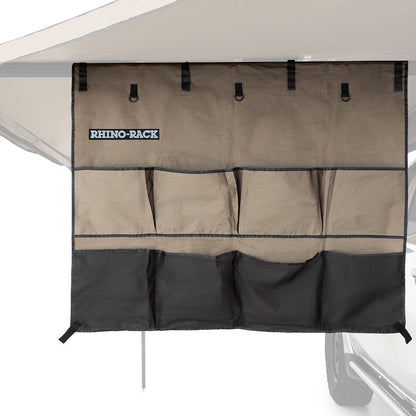 Caravan storage organizer attached to a caravan with Rhino-Rack branding.