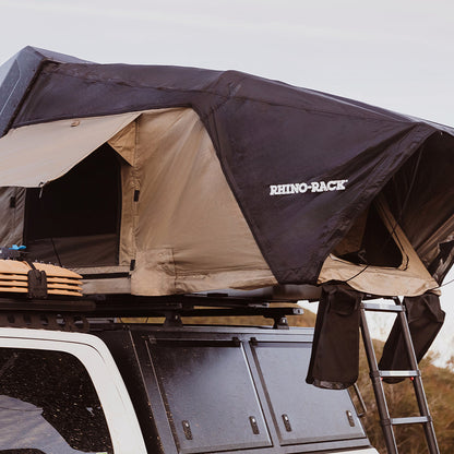 Rooftop tent on a vehicle with a scenic background