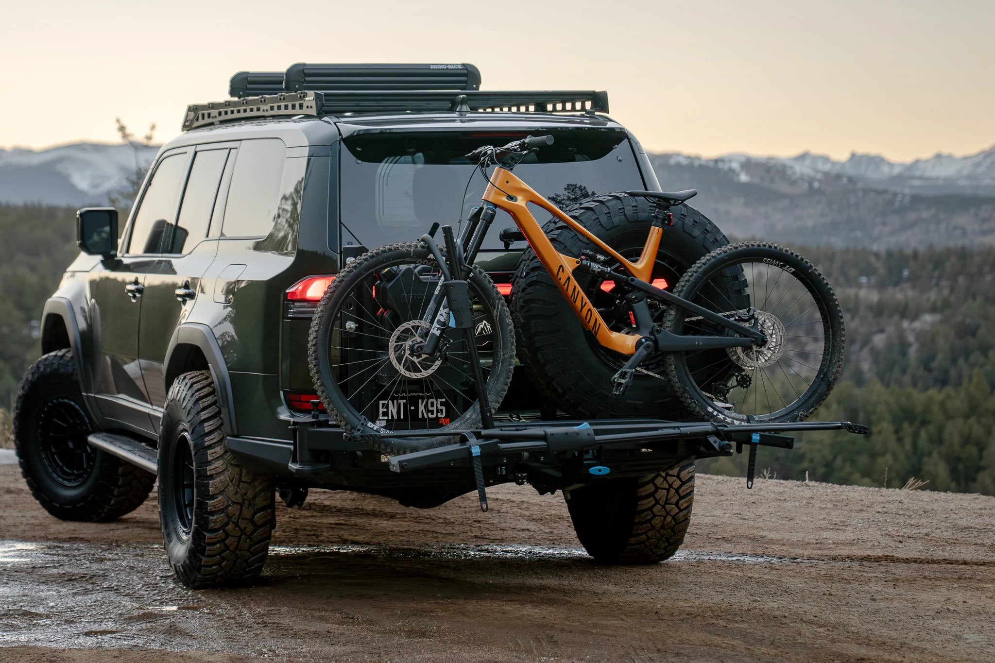 Rockymounts bike rack, carrying mountain bike. Toyota Landcruiser 4wd with mountains in the backdrop.