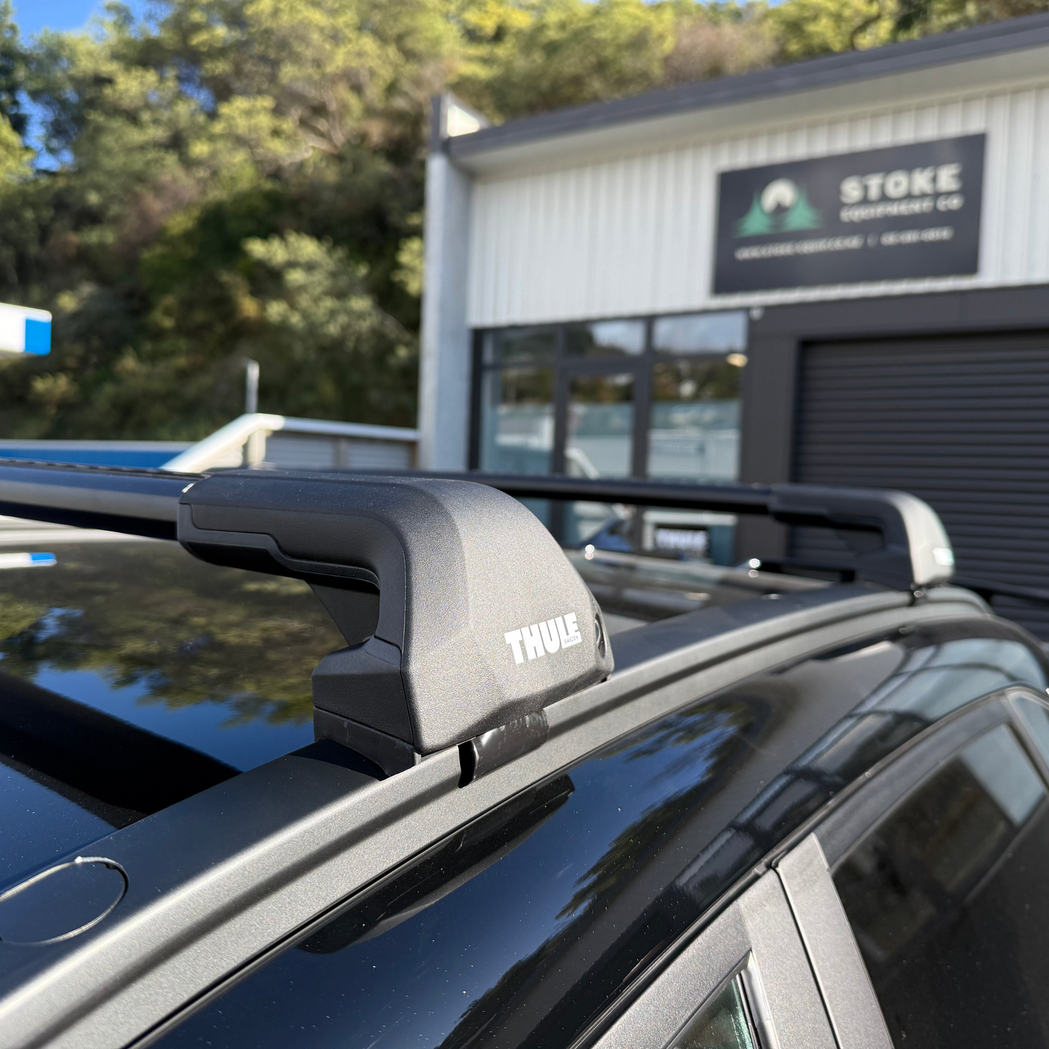 Car roof rack with Thule logo on a vehicle parked in front of stoke equipment co