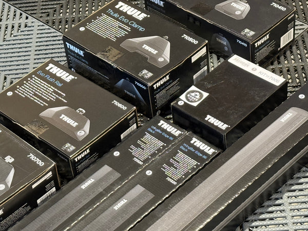 Collection of Thule packaging on a textured surface