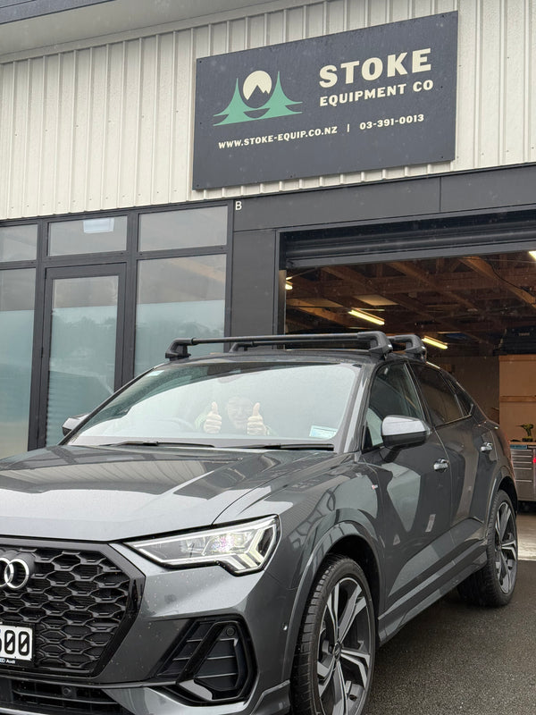 Car parked in front of a building with a sign for Stoke Equipment Co.