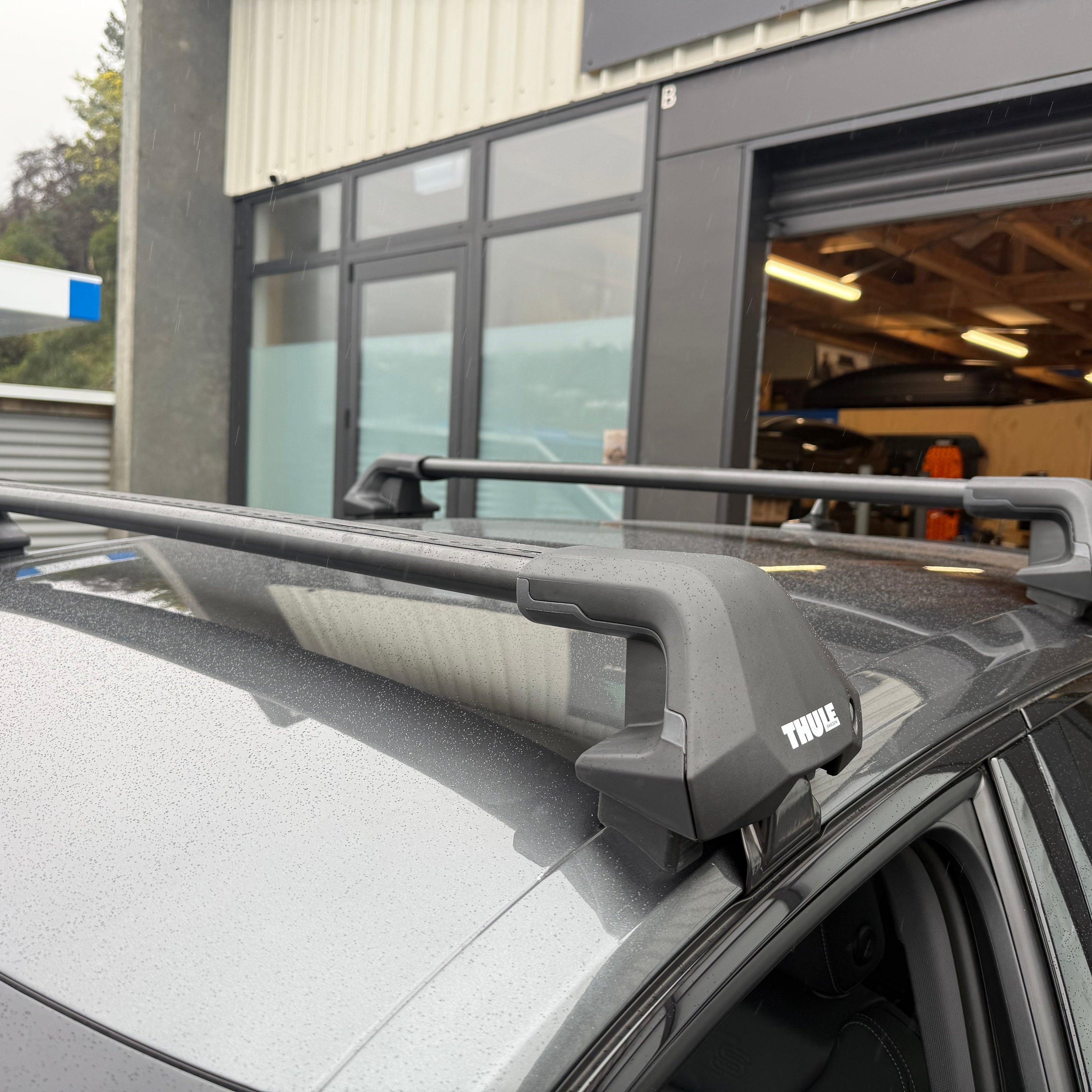Car roof rack system on a vehicle with a building in the background