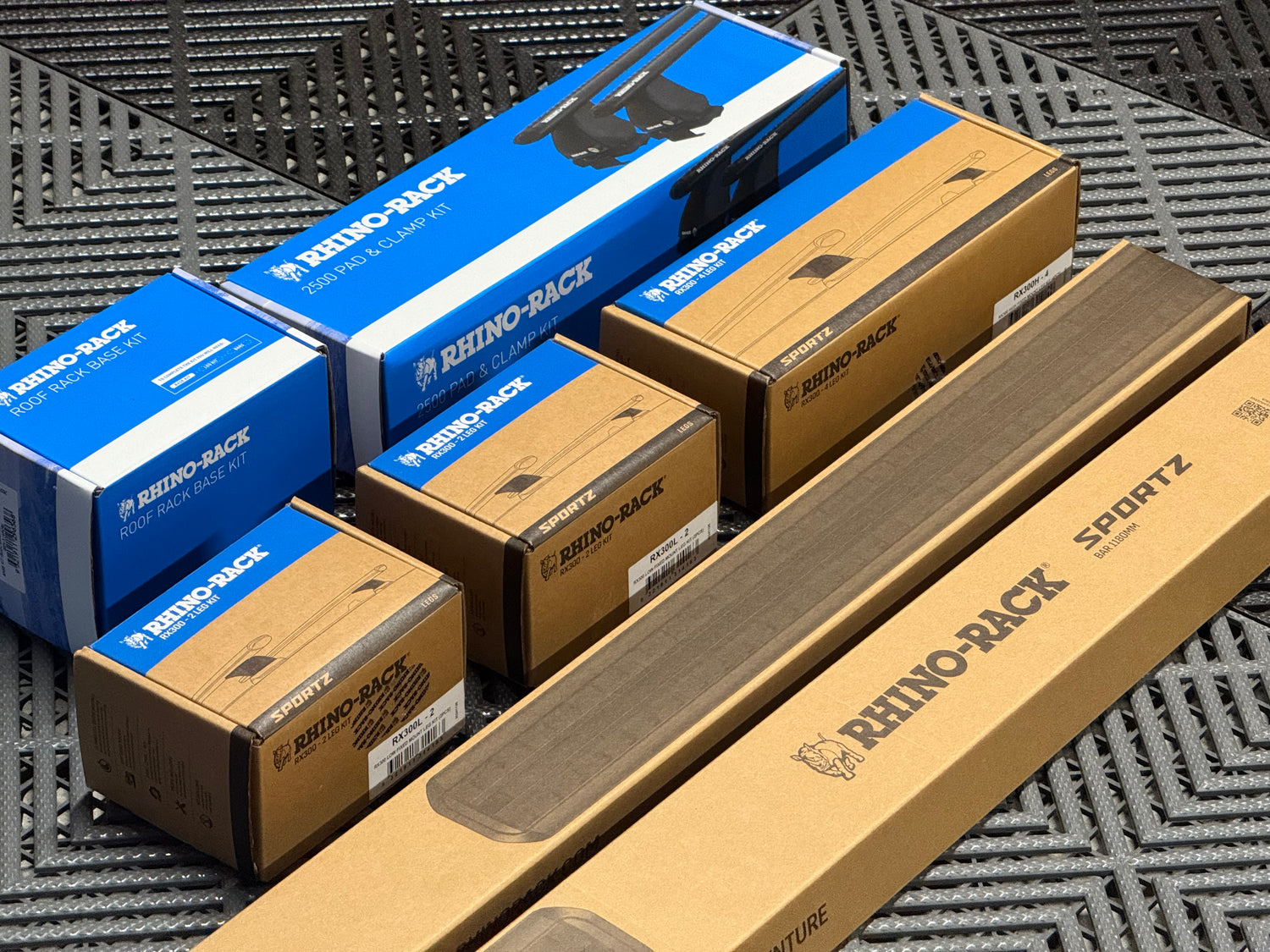 Collection of Rhino-Rack boxes and packaging on a textured surface