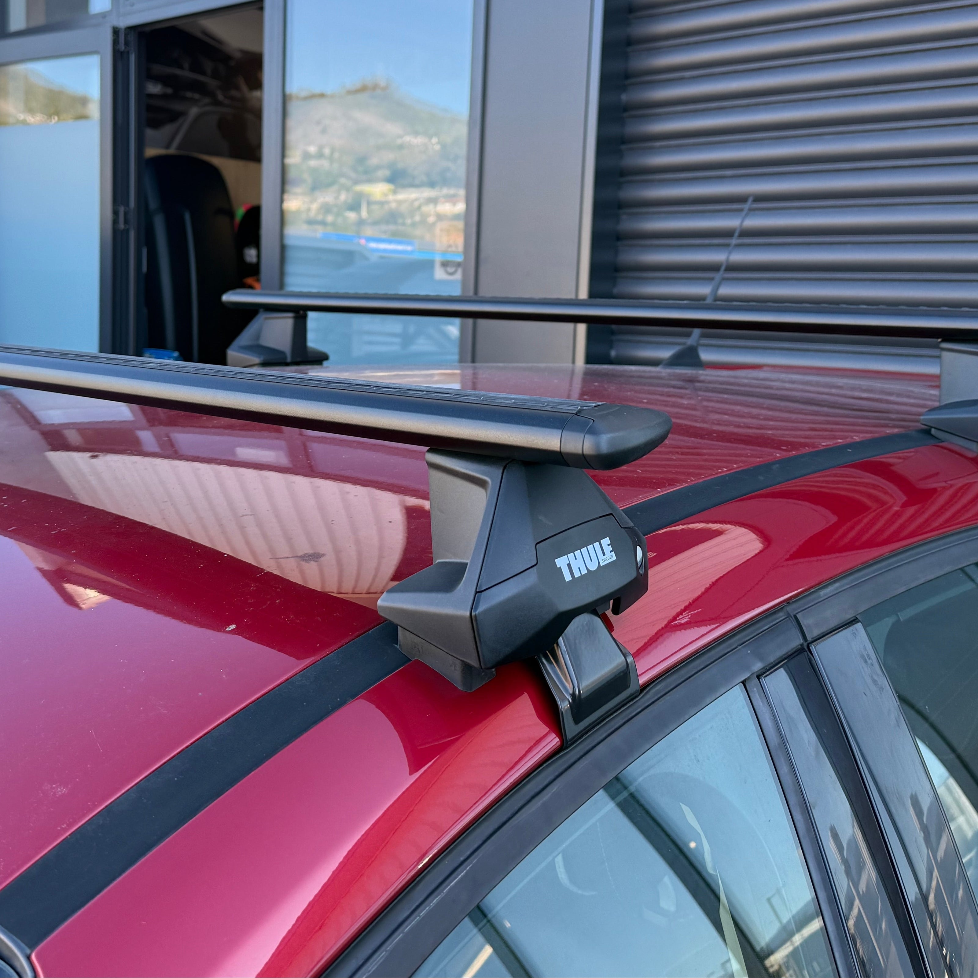 Thule 710500 Clamp Mount roof rack system on a red car at Stoke Equipment Co Roof Rack Store in Nelson NZ