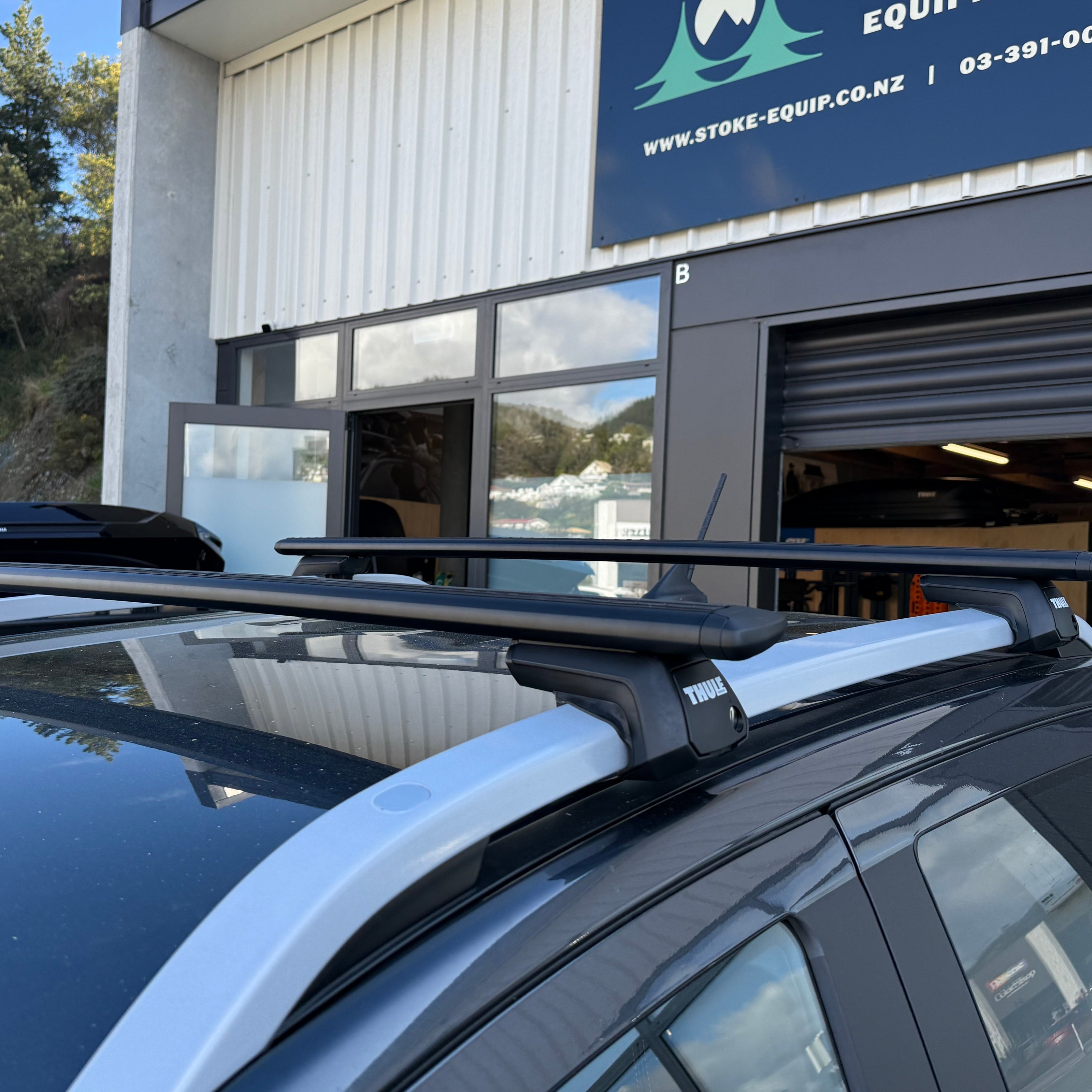 thule 710410 raised rail roof rack system mounted to a vehicle outside stoke equpment co thule specialist store in nelson NZ