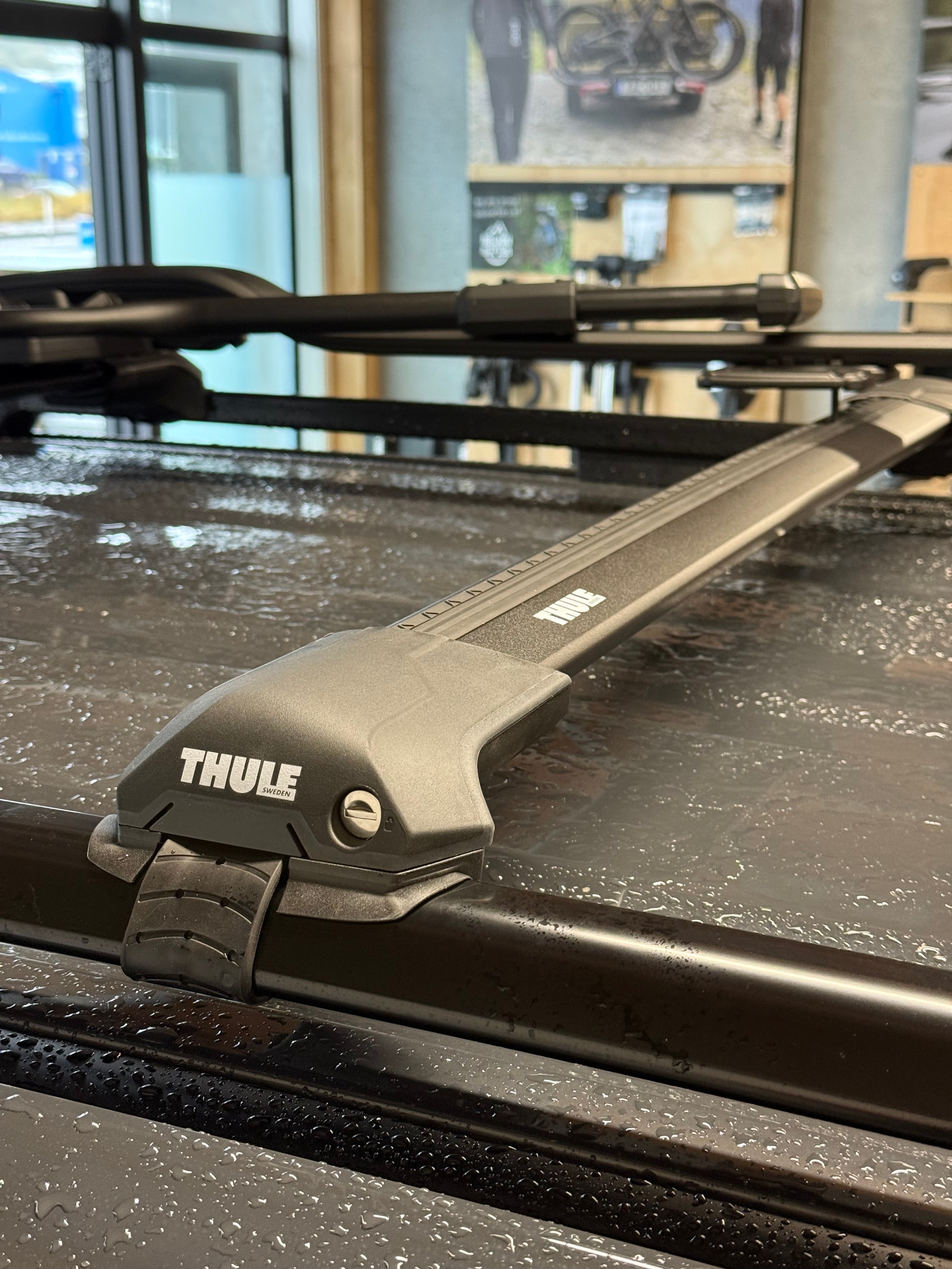 thule wingbar edge 720400 raised rail roof rack kit mounted on a vehicle with a thule proride 598001 bike rack attached