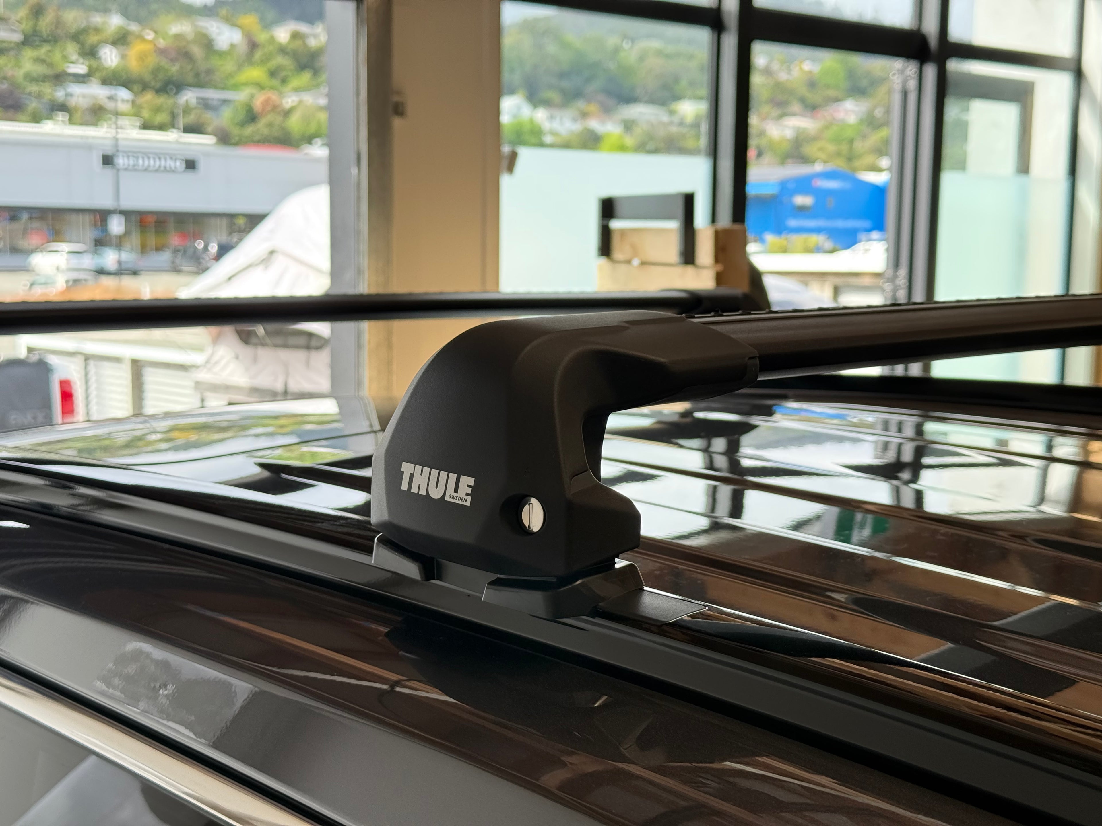Thule wingbar edge black roof rack system on a vehicle at stoke equipment co