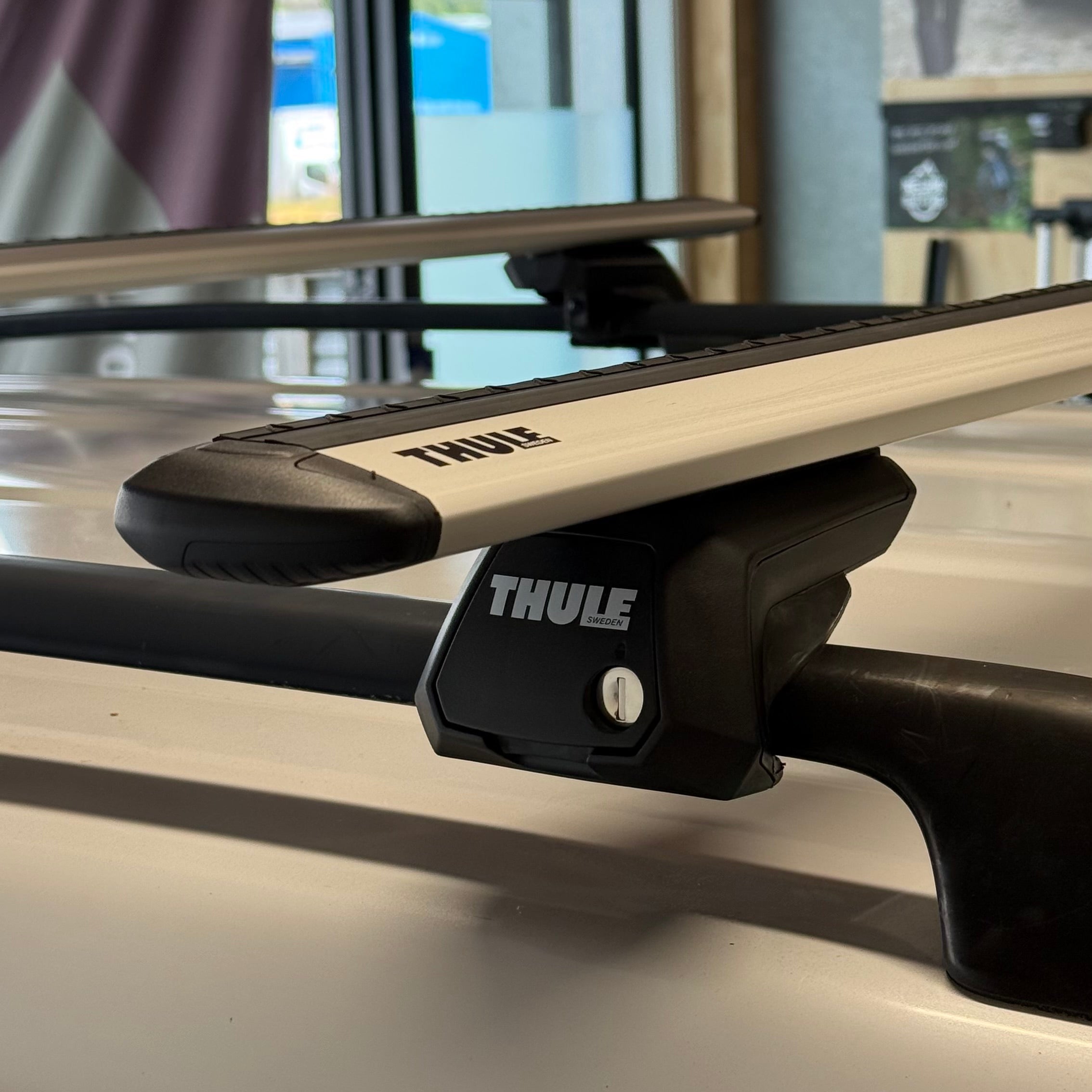 Thule roof rack system on a vehicle with a store interior in the background