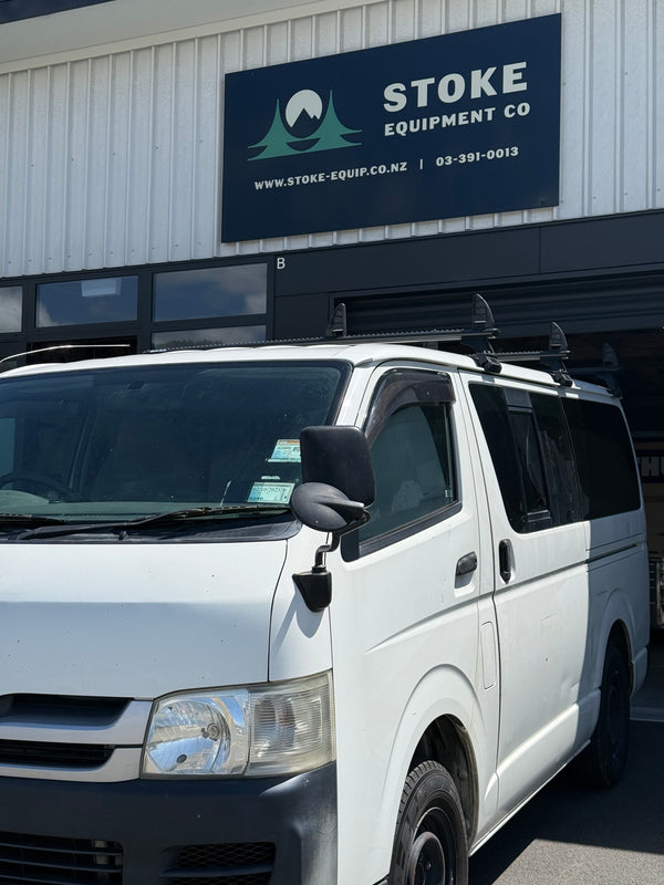 Toyota Hiace parked in front of a building with a Stoke Equipment Co sign.