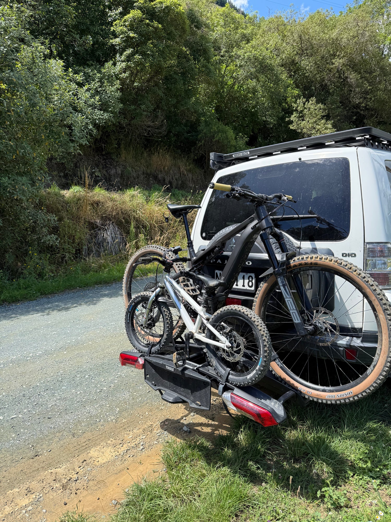 Bicycle on a roof rack of a vehicle with trees in the background