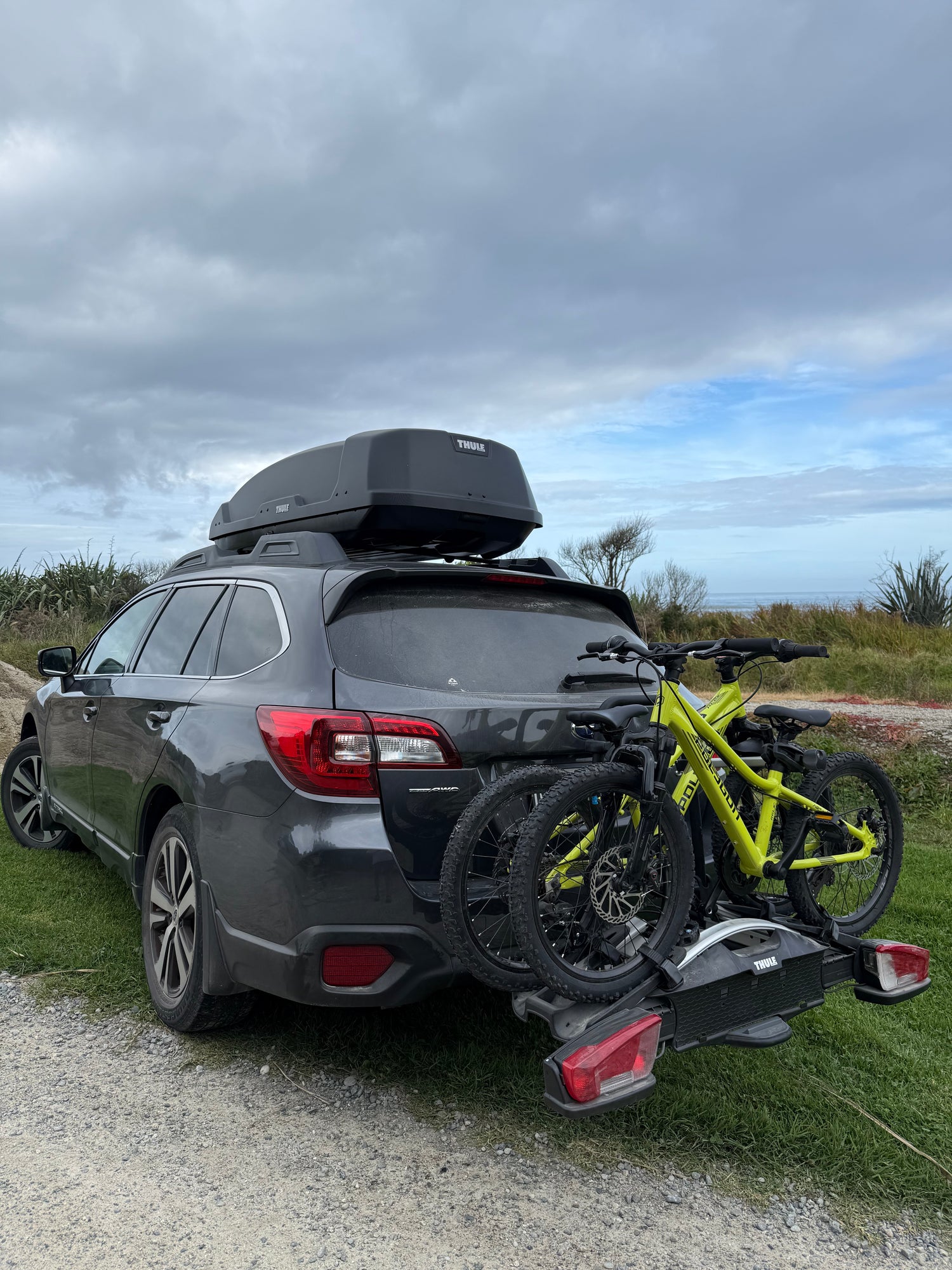 Car with bicycles on a roof rack on a road