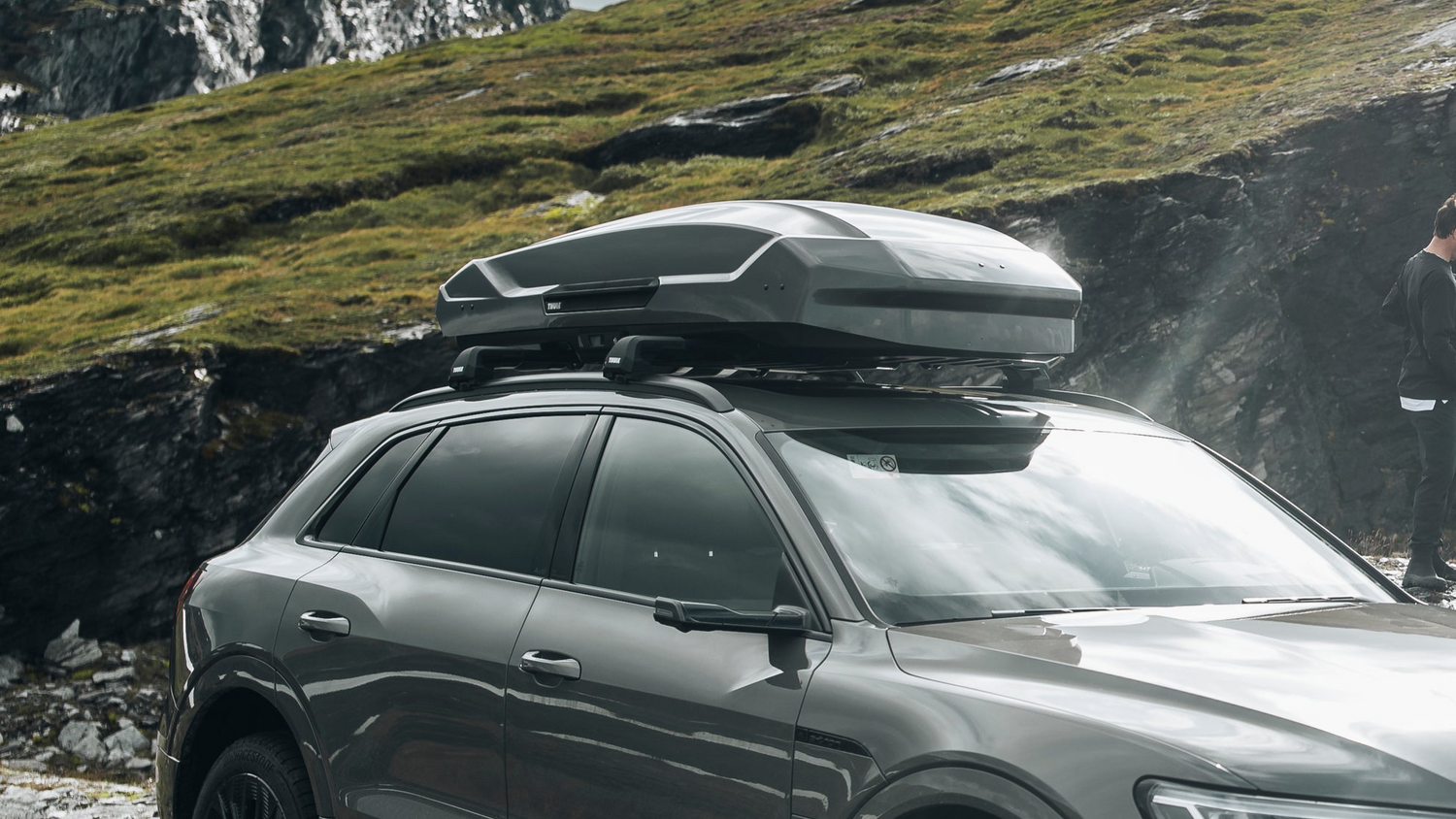 Image of a Thule motion 3 roof box, fitted to a Thule WingBar evo roof rack system on an Audi suv