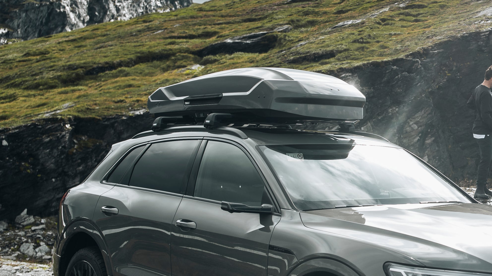 Image of a Thule motion 3 roof box, fitted to a Thule WingBar evo roof rack system on an Audi suv