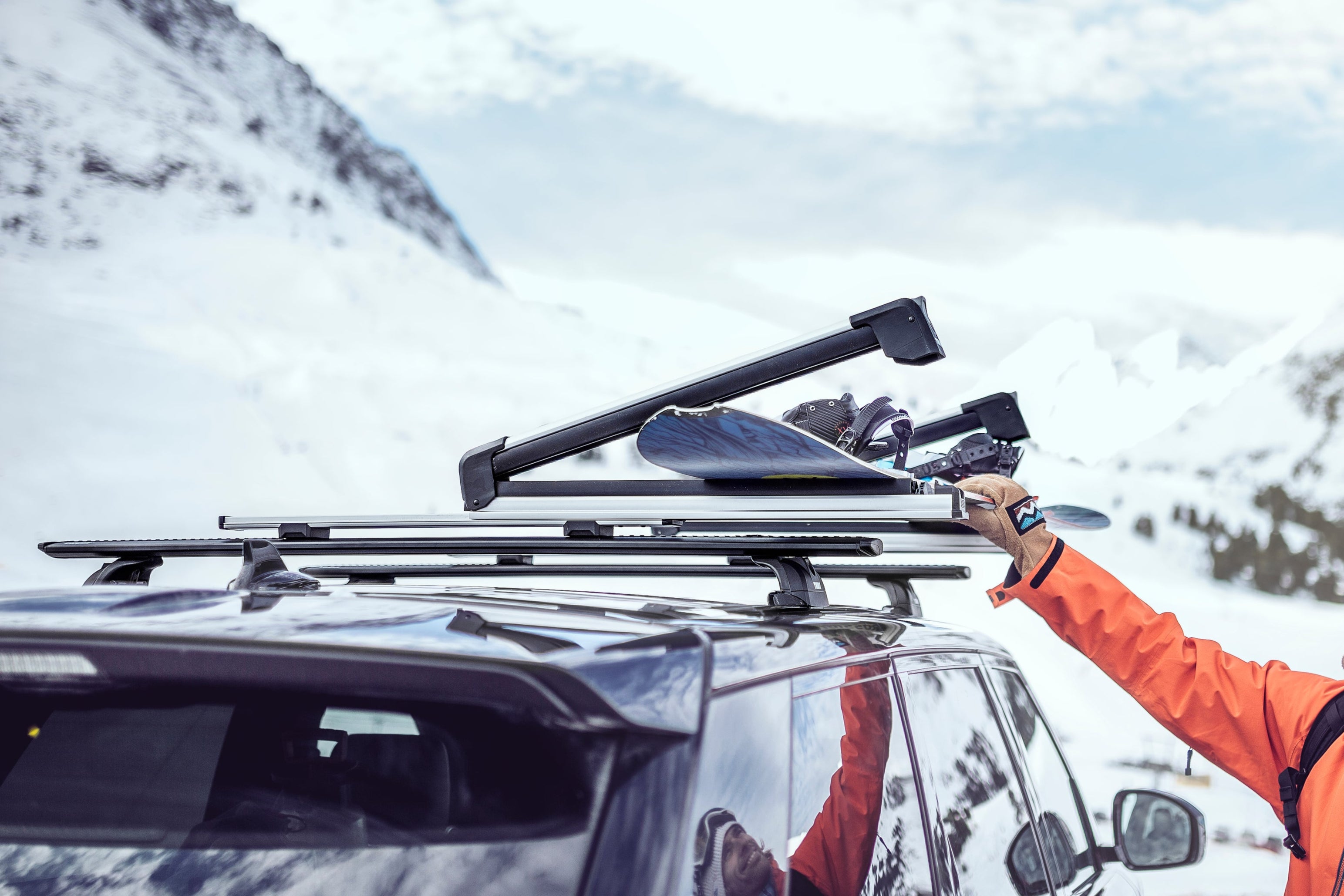 thule snowpack snowboard rack mounted on a thule wingbar roof rack system