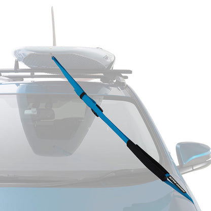 Car with a roof rack and a blue paddle board on a white background