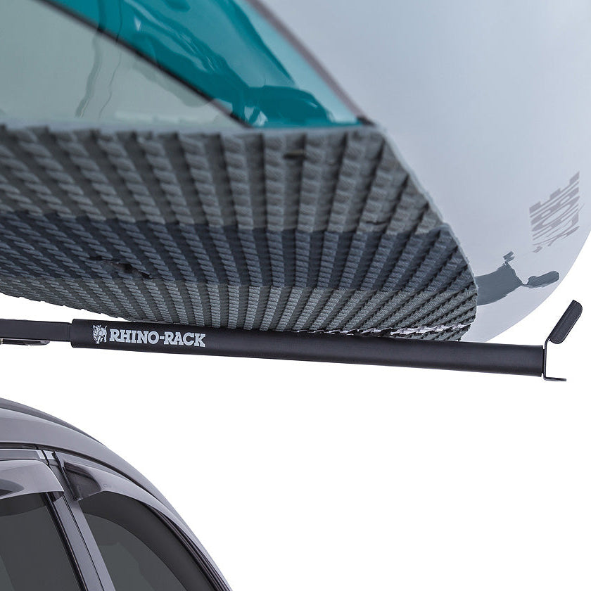 Roof rack system on a car with a kayak attached, featuring the Rhino Rack brand.