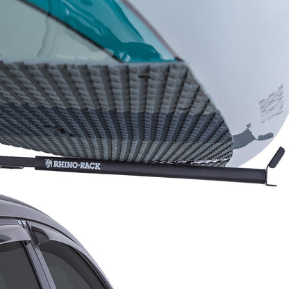 Roof rack system on a car with a kayak attached, featuring the Rhino Rack brand.