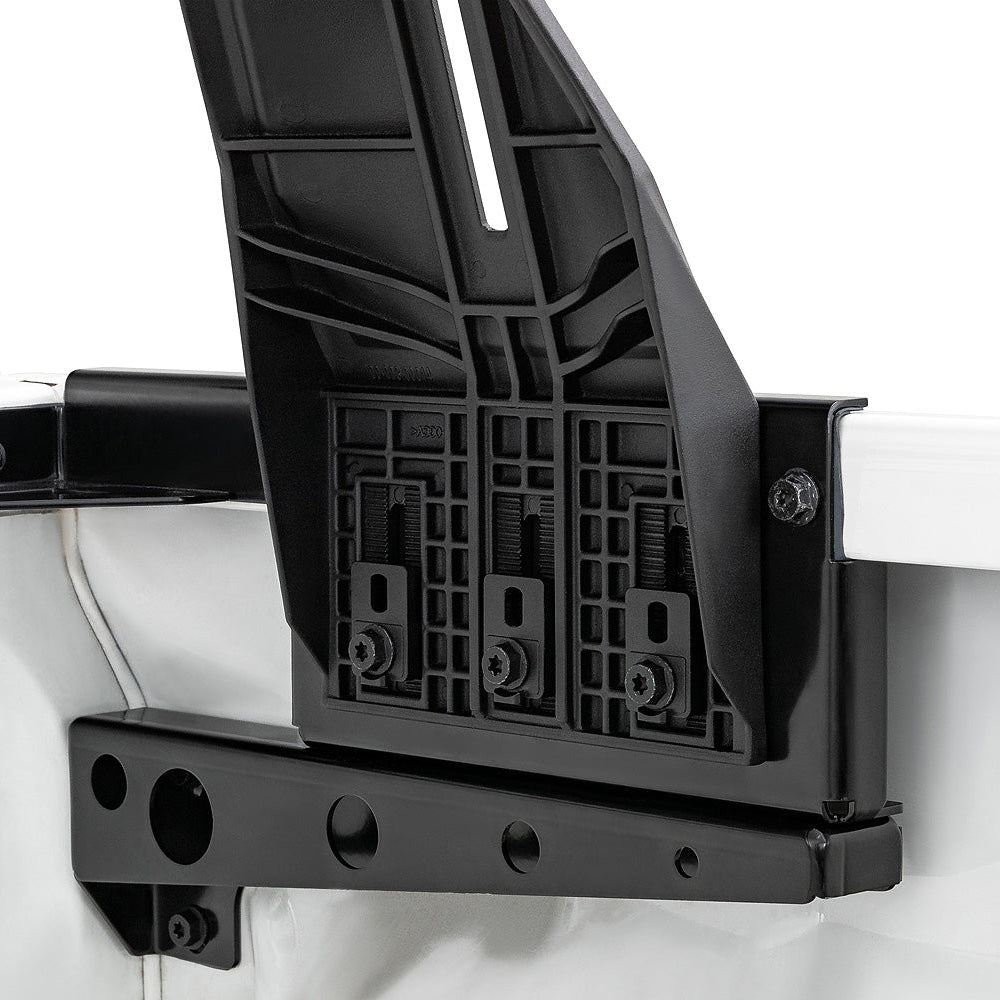 Black metal bracket attached to a white vehicle