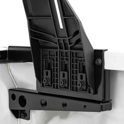 Black metal bracket attached to a white vehicle