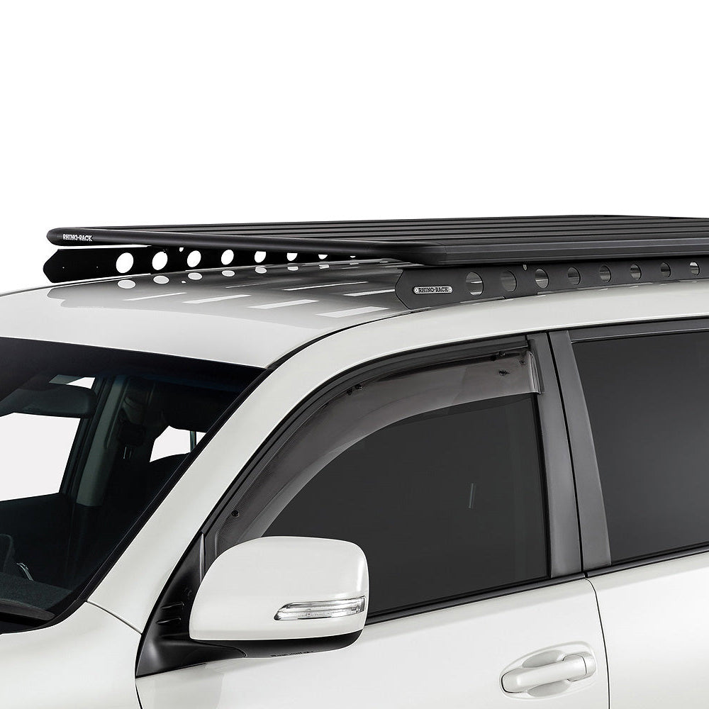 White SUV with a black roof rack on a white background
