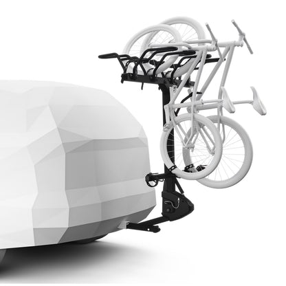 Bicycle carrier attached to a car with two bicycles on a white background