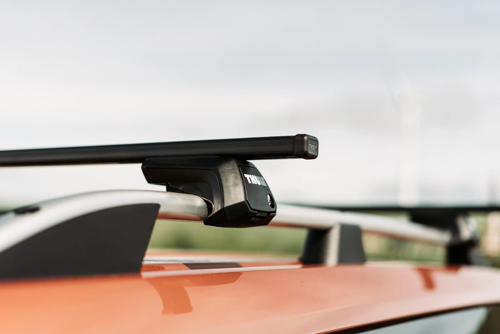 Car roof rack system on a vehicle with a blurred background