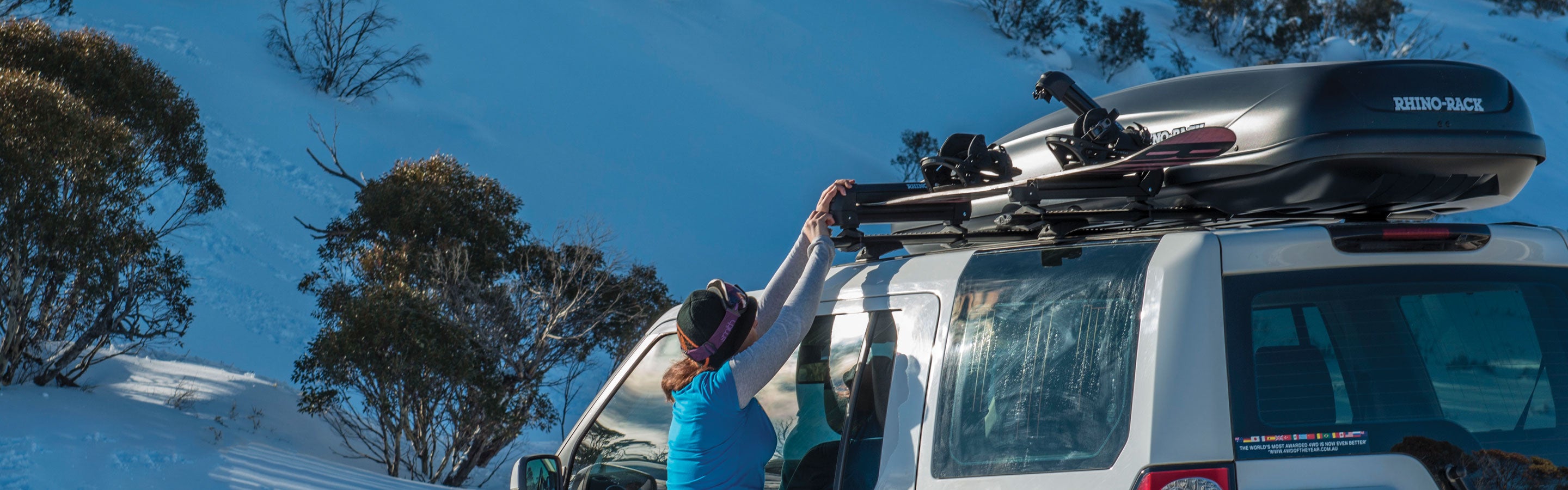 Women loading Rhino-Rack Snowboard Carrier 