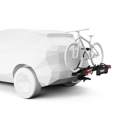 White electric vehicle with a bicycle attached to a carrier on a white background