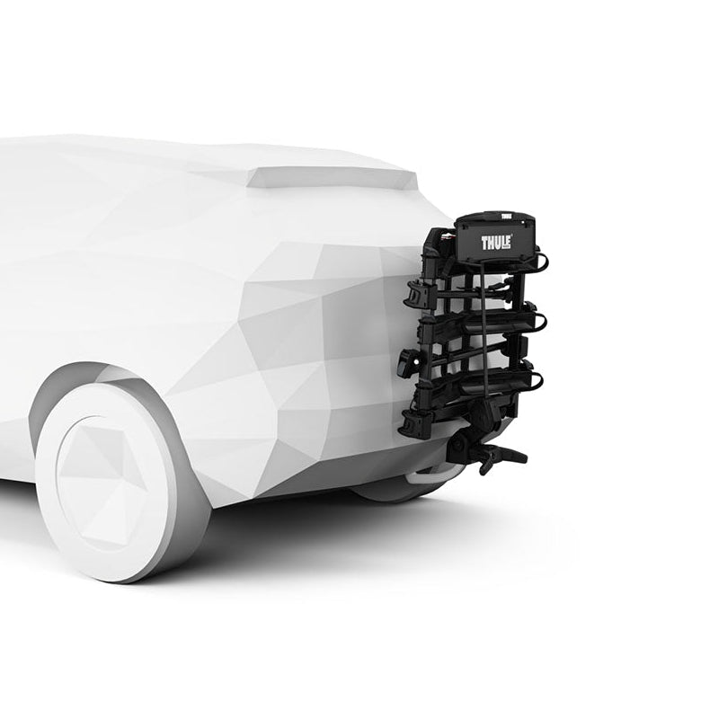 White vehicle with a black thule outpace bike rack on a white background