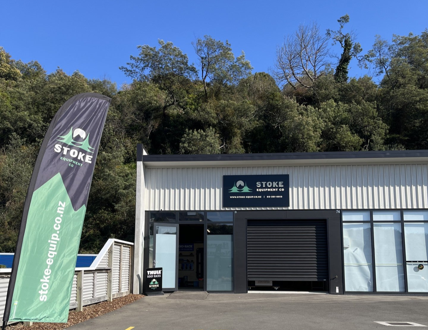 Stoke Equipment Co Roof Rack Storefront, shown from the footpath with signage and flag out the front